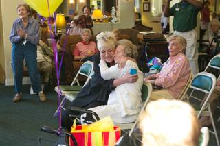 Karen Hall, at left, hugs Lucille Murn who celebrates her 102nd birthday at the Atria Seville Senior Community, Thursday Sept. 27, 2012.